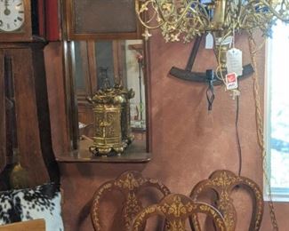 Set of 8 inlaid Italian chairs ( 3 shown) , antique Scandinavian casement clock, heavy bronze religious chandelier from Europe, set of three heavy Italian made wooden chairs, wall sconce made of wagon wheel parts.