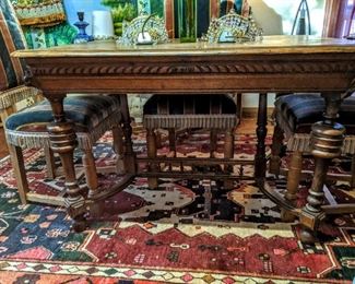 Small European dining or kitchen table with carving and nice stretchers hello, set of 8 Belgian dining chairs, 3 shown here., 5 1/2 by 8 foot handmade Persian rug.