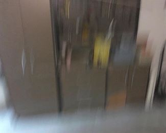 Blurry pic but beautiful garage wall cabinets with tall storage, drawers and place for hanging tools.