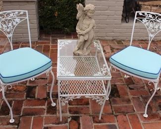 Two chairs shown with two tiered side table.