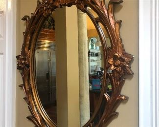 Ornate mirror reflects the future and the future is warning you to watch out for big columns that want you to run face-first into them