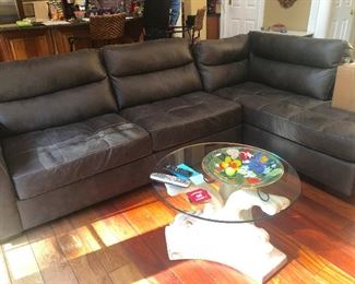 Faux leather sofa in perfect condition. Glass coffee table with base made of ice sculpture