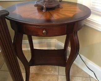 Bow leg side table with outie belly button