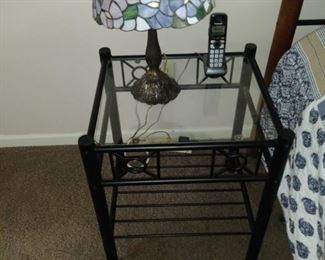Tiffany lamp on glass top bedside table