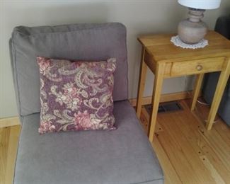 One of two casual chairs with one drawer stand