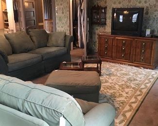 TV ROOM WITH SOFAS, RUGS, CHESTS