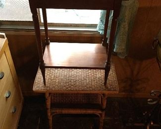 Two of several end tables; these vintage wicker and a walnut one