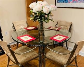 Glass top dinette with four chairs.