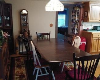 Dining Room Table with 4 matching chairs. Has leaf to expand even larger