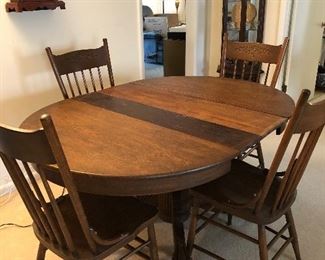 21	Round oak dining table (no leaves) 48" diameter with 4 rolling chairs. Table top as is condition.	 $100.00 	   