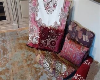 Assorted area rugs and pillows