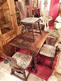 TUDOR STYLE TABLE, CIRCA 1920's, WITH DRAW LEAVES AND 4 CHAIRS WITH CARVED FLORAL ACCENTS ON SEAT BACKS