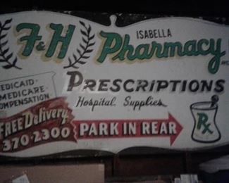Huge metal sign from Fred Isablella's Pharmacy on Union Street.