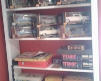 collection of die cast cars and vintage games