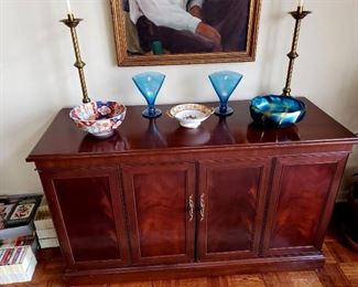 Entertainment center, brass altar candles, Imari bowl, Noritake, Fenton stretch glass fan vases, Tiffany Favrile bowl