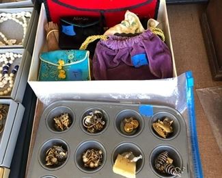 Assorted earrings and jewelry satchels