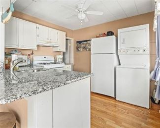 Cute, clean white kitchen. Gas washer/dryer combo