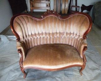 Vintage Victorian style hand carved love seat with tufted upholstery.