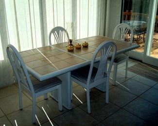 Tile inlaid kitchen table with eight chairs. (four shown)