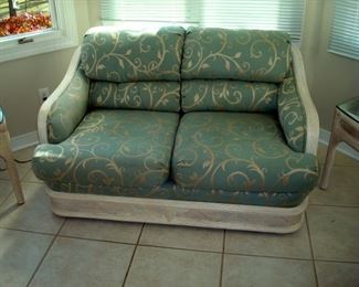 Loveseat with white arms and base.