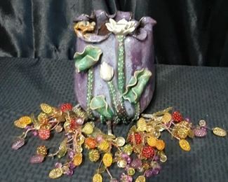Handmade Asian pottery with plastic grape vines