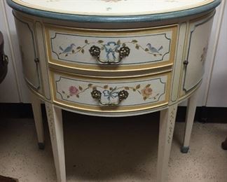 Painted half-circle accent cabinet.