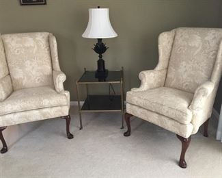 Matching off-white armchairs, table and lamp.