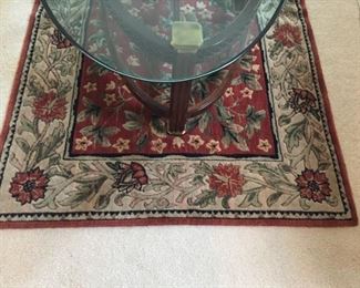 Oriental rug and glass and brass table.