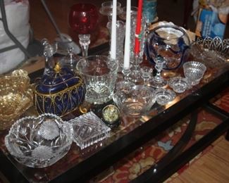 Selection of glass pieces on glass coffee table.