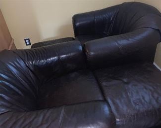 Two leather chairs with ottomans 