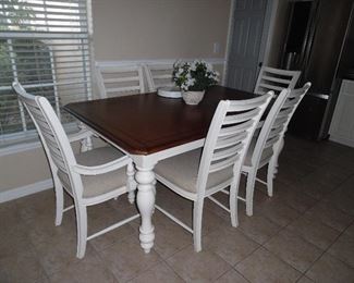 Haverty dining set. Rectangular table with wood top and 1 leaf. 4 side chairs, 2 Captain's chairs, upholstered seats.