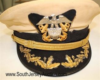 Lot 149: Lot of Personal Effects of Veteran of WWII, Korea, and Vietnam John D. McIntosh including WWII USN Officers Visor Cap, Photo of John D. McIntosh, 2 Military Photos, Front Band, and 2 Extra Hat Covers in the Original Shipping Box