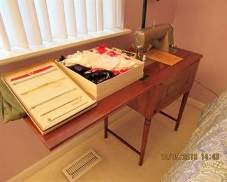 vintage singer sewing machine in cabinet with accessories