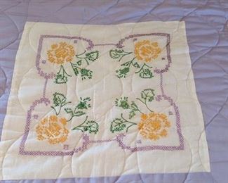 Cross stitch panels on hand made quilt