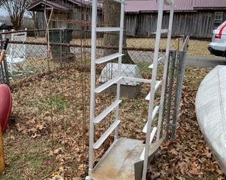 #99	outside  	metal tall shelf  for trays 	 $100.00 
