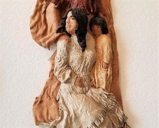 Leather sculpture of Indian maiden and warrior.