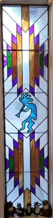 This is a tremendous piece of art...stained glass Kokopelli window.
