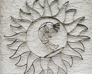 Large metal Kokopelli sun wall art.