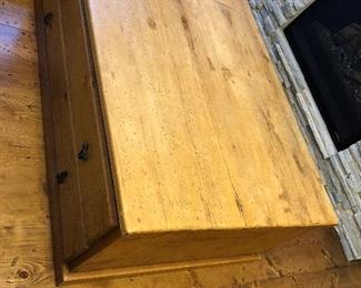 Wood coffee table with “distressed “ look. 34” deep, 49” wide 18” tall. 4 wide drawers, 2 on each width sides