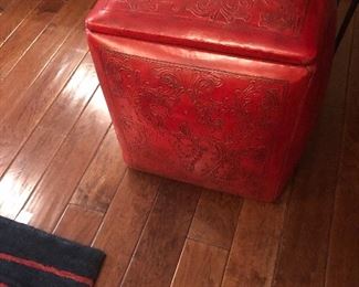 2 red leather stools great for storage too