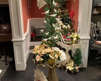 An antique birdbath holds miniature poinsettias and the white dove Christmas tree