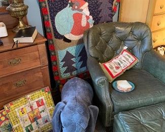 What a great Christmas quilt behind the green leather chair