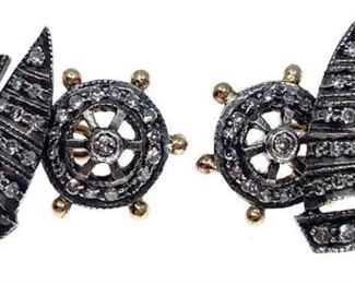 Handsome sterling silver and gold cufflinks designed as sailboats. One side styled as a sailing boat other side a steering wheel, set with single cut diamonds. Total estimated diamond weight 0.44 ct.; overall weight 4.6 gm. Length: .75 in. Condition: Overall good

