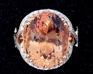 Exceptional 14k rose gold ring set with an oval faceted cut morganite, weighing 9.10 ct.; further accentuated and surrounded with round cut diamonds, .067 ct.  Overall weight 9 gm. Ring size: 7 Condition: Very good
