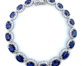 Beautiful 14K Ladies White Gold Custom Diamond and Blue Sapphire Bracelet. 16.65 GR TW 18 counts natural sapphire set in 4 prongs setting. Carat weight 18.07 CTS. 18 Counts. Oval Cut approximate 4 x 6 to 6 x 8mm. "Diffused" quality blue sapphire, fine cut and clarity. Permanent treatment. Natural round brilliant cut diamonds, 4.00 cts. Quality G/H Color, I Clarity. Total Gemstone Weight: 22.07 CTS TW.  Length: 7.5 in. Condition: All fine cutting and proportions. All prongs settings style. IAS Appraisal included.
