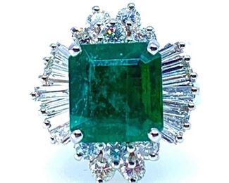14KT white gold ladies emerald and diamond ring. The featured emerald is set within a diamond bezel, supported by a ribbed under gallery, completed by a two millimeter wide band. Bright polish finish. Identified markings "K14"  One prong set square emerald standard step cut natural emerald, measuring 10.00 x 9.50 x 6.34mm. Approximate weight of 4.15ct. Clarity is heavily included, type III, medium dark, moderately strong, very slightly bluish green color (GIA vslbG 6/4). Cut is good. 10 prong set round brilliant cut diamonds, measuring 2.60-2.60 x 1.56mm. Approximate total weight of 10 Stones = 0.65ct. Clarity I-1. Color G-I 14 prong set baguette cut diamonds, measuring from 3.50 x 1.30 x 1.11mm to 3.70 x 1.50 x 1.28mm. Approximate total weight of 14 stones 0.78ct. Clarity VS-1 to SI-1. Color G-H Total Weight Colored Stones 4.15ct. Total Weight Diamonds 1.43ct. Total Weight Ring 6.70gm  Ring Size: 4.75-5 Condition: Very good AIG Appraisal Included
