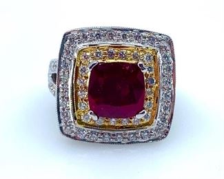 14KT white gold cast and assembled ruby and diamond ring. The featured ruby is set within an inner and an outer diamond bezel, supported by an elaborate lattice under gallery and tapering diamond set shoulders, completed by a three millimeter wide band. Bright polish finish with yellow gold accents throughout. Markings "14K".  One prong set square cushion mixed cut natural ruby, measuring 9.06 x 9.06 x 5.00mm, approximate weight of 4.76ct. Clarity is heavily included, type II, dark, very slightly brownish, red color (GIA R 7/3). Cut is good. 96 prong set round brilliant cut diamonds, measuring 1.80-1.50 x 1.01mm. Approximate wight of 96 stones = 1.67ct. Clarity SI-1 to I-1. Color F-H Total Weight of Stone . 4.76ct. Total Weight of Diamonds . 1.67ct. Total Weight of Ring . 15.60gm  Ring Size: 6 Condition: New, good workmanship AIG Appraisal Included
