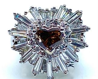 14K white gold ring with a bright finish. The ring is mounted with one genuine fancy color diamond center stone weighing approximately 0.82 carat and 42 genuine faceted accenting diamonds weighing approximately 1.68 carats. Natural Heart Shaped Brilliant Cut Fancy Brown Diamond 6.6 x 4.6 mm . 0.82 carat. Color Grade, Fancy Brown. Clarity Grade S12. Symmetry Good. Polish Very Good. 42 Natural Baguette/Round Brilliant Cut Diamonds. 2.5-4.5mm (28 baguette). 1.5-1.6mm (14 round). Total weight 1.68 carats. Color Grade G-H. Clarity Grade VS2-SI2. Fancy Color Diamond Weight . 0.82 cts. Total Diamond Weight . 2.50 cts. Total Weight of Ring 6.4 grams of 14K White Gold  Ring Size: 6 Condition: New, excellent workmanship AIGL Appraisal Included

