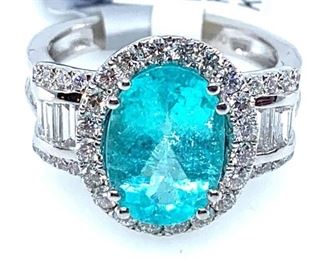 Platinum ladies cast and assembled Paraiba tourmaline and diamond ring featuring a Paraiba tourmaline set within a diamond bezel, supported by mirroring diamond galleries on either side and diamond set shoulders, completed by a two and one half millimeter wide band. Bright polish finish. Marked "PT950". Trademark is Orianne.  1 prong set oval modified brilliant cut natural tourmaline measuring 11.88 x 8.16 x 5.27mm, exact weight 3.31ct. Clarity moderately included, medium light, moderately strong, greenish blue color (GIA gB 4/4) . Cut is good. 27 channel set baguette cut diamonds approximate total weight of 20 Stones = 0.85ct. Clarity VS2-SI1 . Color F-G 36 prong set round brilliant cut diamonds approximate total weight of 36 Stones = 0.80ct. Clarity SI-1 to SI-2. Color F-H Total Weight of Diamonds 1.65ct. Total Weight of Ring 9.99gm  Ring Size: 6.5 to 6.75 Condition: New, good workmanship AIG Appraisal Included
