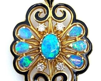 Lovely Victorian style designed 14K yellow gold brooch and/or pendant with black enameled scroll design, with one center oval opal and six pear shaped opals in fine blue green color accented with four round brilliant cut diamonds. Stamped 14K. Stamped LaTriomphe. 13 gm. Length: 1.25 in. Condition: Very good